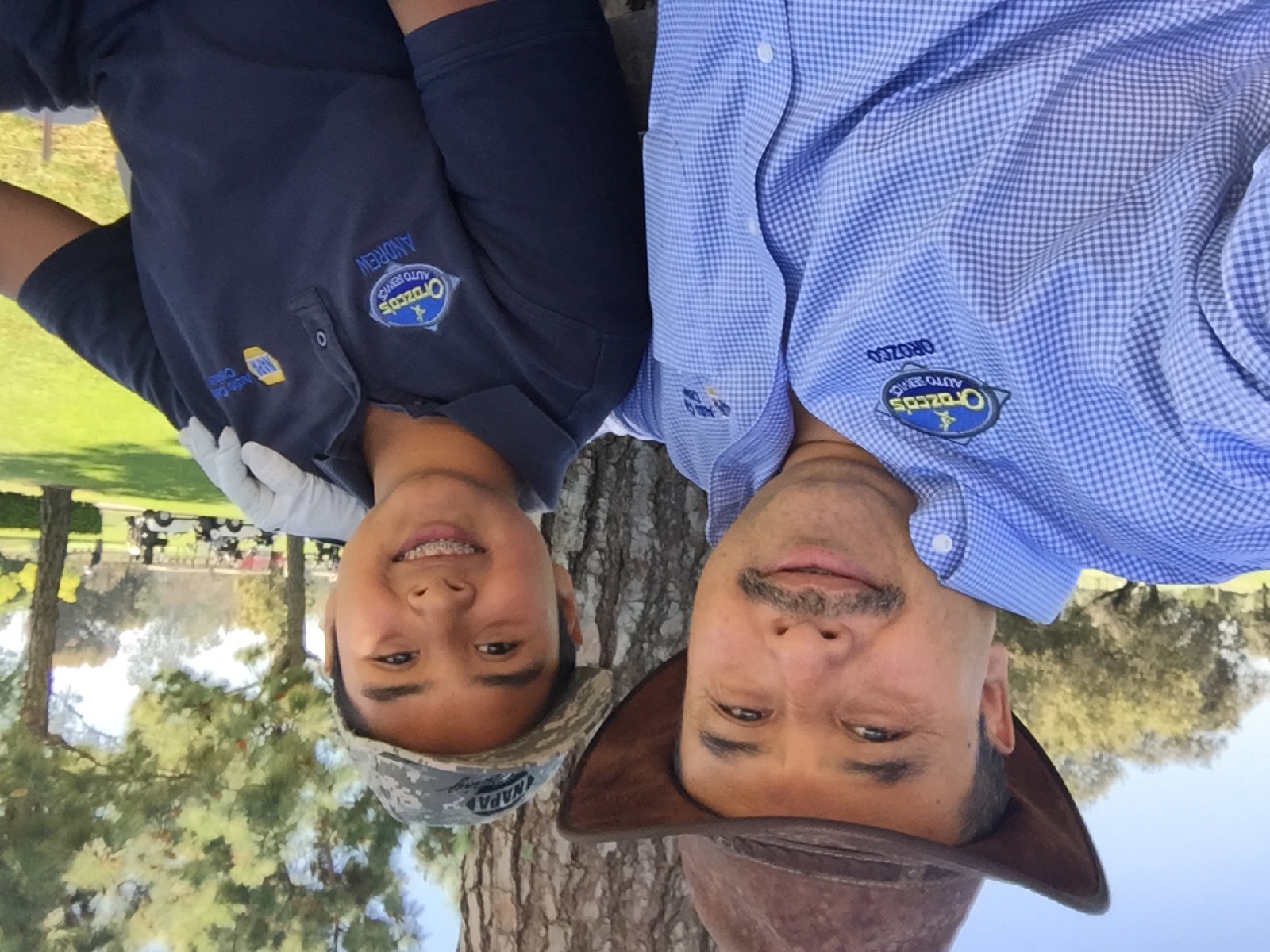 A teenage Andrew Orozco in an Orozco's Auto Service polo with his name embroidered on it, beside his father Servando