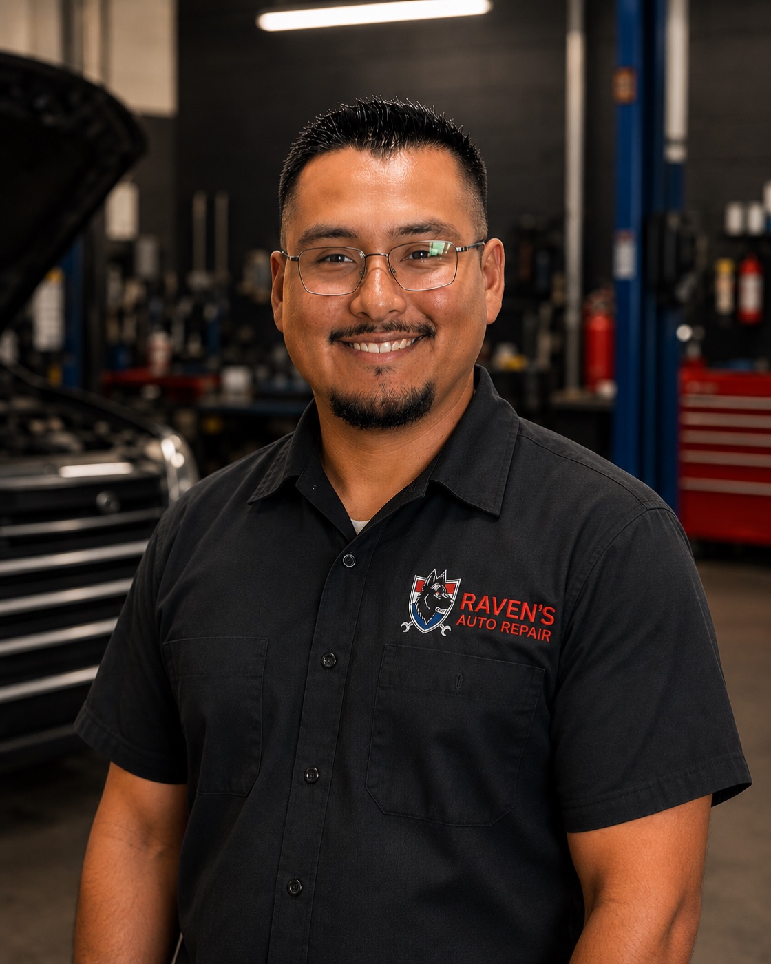 Andrew Orozco in a Raven's Auto Repair shirt in the workshop